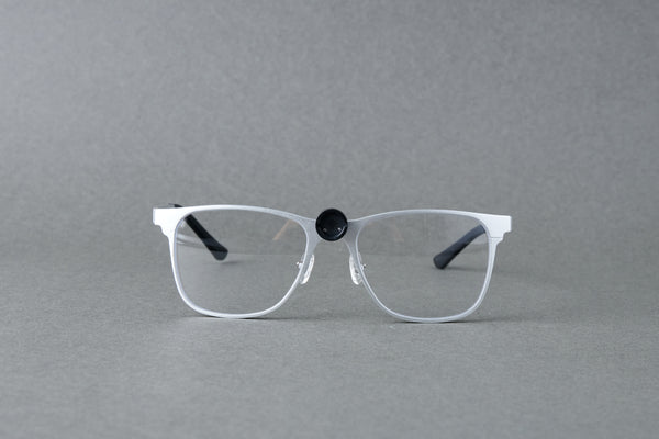 Clear eyeglasses with black accents on a gray background