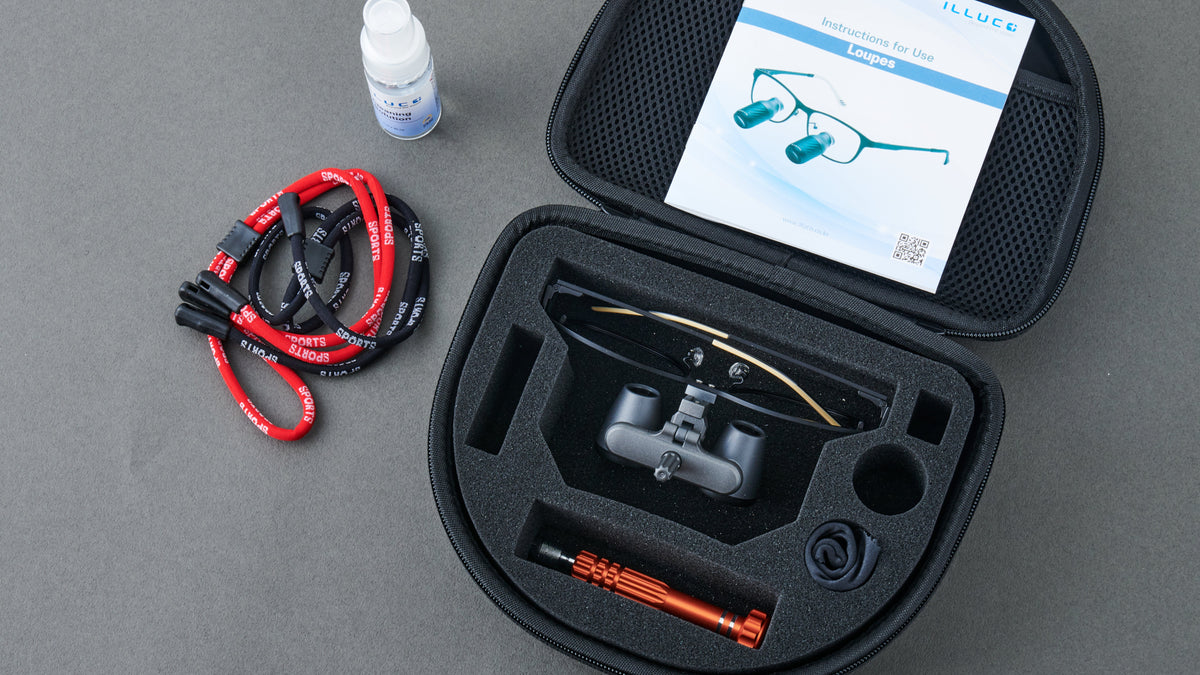 Goggles in a case with accessories on a gray surface
